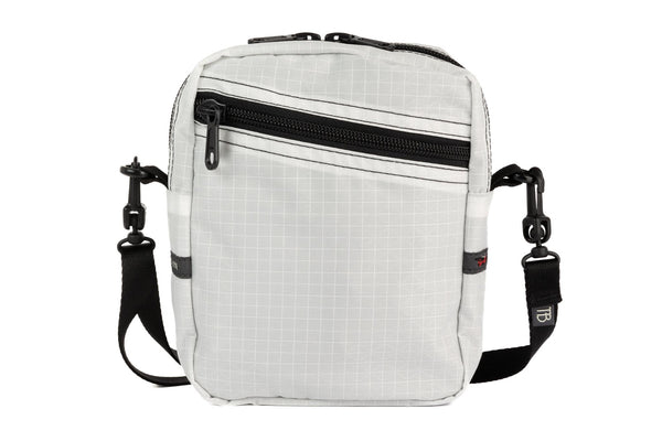 An Everyday Cubelet in Tahoma Halcyon (white with a white grid) with a front zipper.